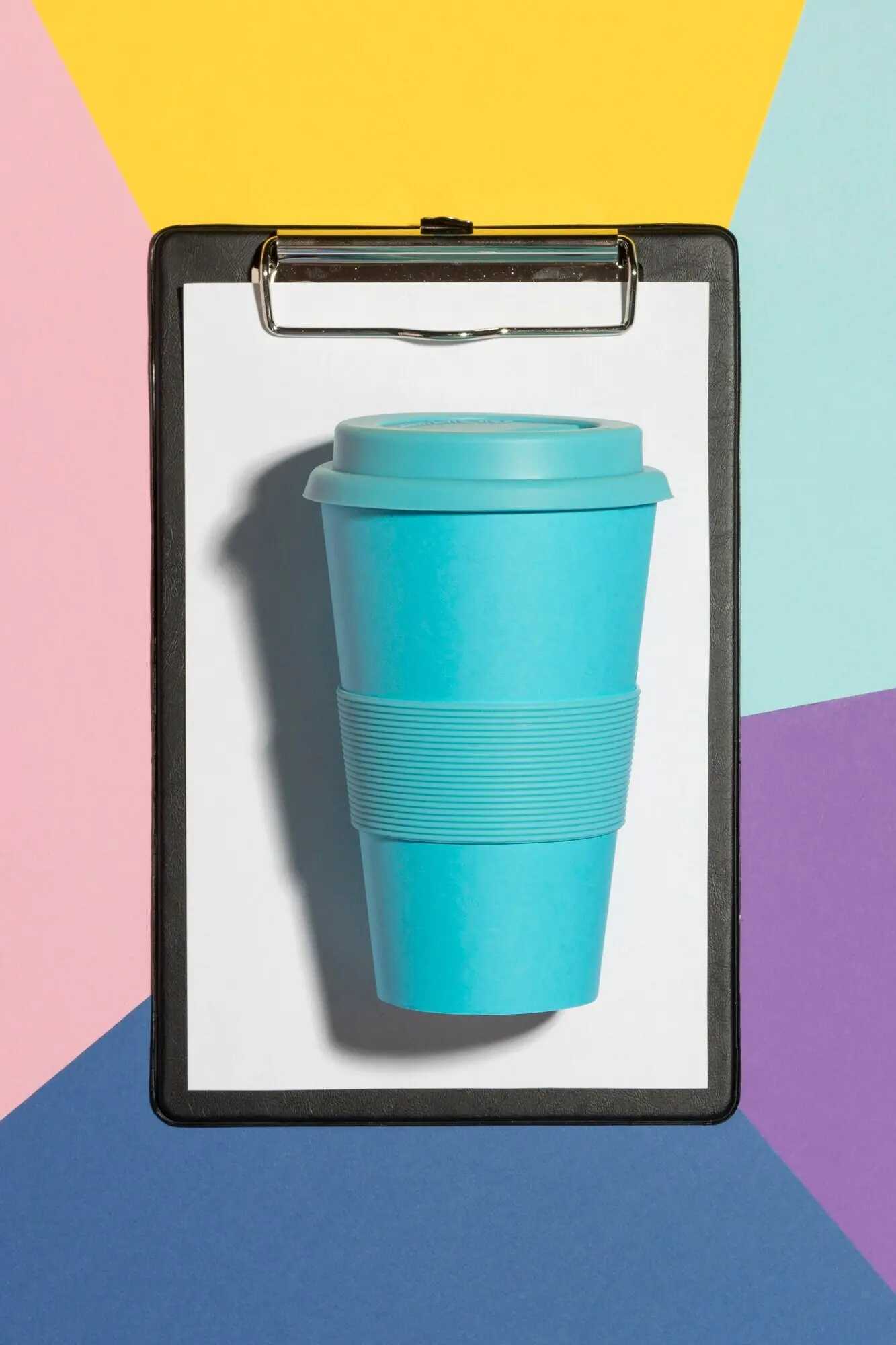 Top view of an eco-friendly reusable cup with a clipboard.